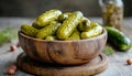 Pickled cucumbers in bowl on wooden rustic board Royalty Free Stock Photo