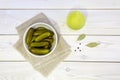 Pickled cucumbers in a ceramic bowl, pickle juice in glass. Homemade marinated gherkins. Top view. Royalty Free Stock Photo