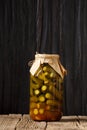 Pickled cucumbers in a jar on a dark background close-up Royalty Free Stock Photo