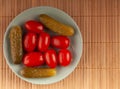 pickled cucumbers and tomatoes on a plate