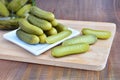 Pickled cucumbers on wooden board