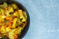 Pickled fermented cucumbers and carrots in a dark salad bowl. Top View Royalty Free Stock Photo