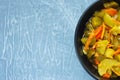 Pickled fermented cucumbers and carrots in a dark salad bowl. Top View. Copy space in left Royalty Free Stock Photo