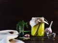 Pickled fermented cucumbers in a glass jar. Pickles with garlic, pepper and dill on a dark brown wooden background Royalty Free Stock Photo