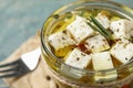 Pickled feta cheese in jar on blue table Royalty Free Stock Photo