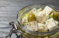 Pickled feta cheese in jar on grey wooden table Royalty Free Stock Photo