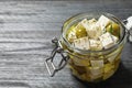 Pickled feta cheese in jar on grey wooden table Royalty Free Stock Photo