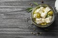 Pickled feta cheese in jar on grey wooden table. Space for text Royalty Free Stock Photo