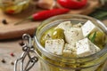 Pickled feta cheese in jar on wooden table Royalty Free Stock Photo