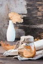 Pickled fly agarics in a jar on a wooden table. Microdosing and Alternative Medicine. Vertical view