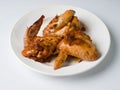 Pickled fried chicken wings on a white plate