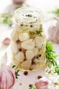 Pickled garlic with herbs.