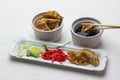 Pickled ginger, chopped leeks and gyoza on plate. Gyoza dumplings in bowl