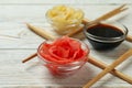 Pickled ginger, soy sauce and chopsticks on white wooden background Royalty Free Stock Photo