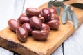 Pickled greek kalamata olives on wooden board Royalty Free Stock Photo