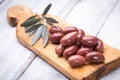 Pickled greek kalamata olives on wooden board Royalty Free Stock Photo