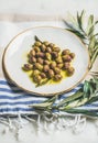 Pickled green Mediterranean olives and olive tree branch Royalty Free Stock Photo
