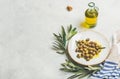 Pickled green Mediterranean olives, olive tree branch and oil Royalty Free Stock Photo