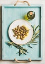 Pickled green Mediterranean olives, olive tree branch, virgin oil Royalty Free Stock Photo
