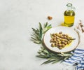 Pickled green Mediterranean olives, olive tree branch and virgin oil Royalty Free Stock Photo