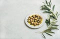 Pickled green Mediterranean olives in virgin oil and olive-tree branch Royalty Free Stock Photo