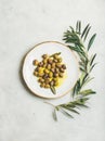 Pickled green Mediterranean olives in virgin olive oil on plate Royalty Free Stock Photo