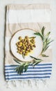 Pickled green Mediterranean olives on white ceramic plate, top view Royalty Free Stock Photo