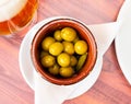 Pickled green olives with cucumber - typical Spanish tapas olivas verdes y pepinos