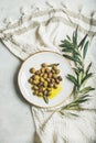 Pickled green olives in olive oil on white ceramic plate Royalty Free Stock Photo