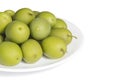 Pickled green olives on the white porcelain plate Royalty Free Stock Photo