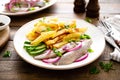 Pickled herring fillet with onion and fried potato on plate Royalty Free Stock Photo