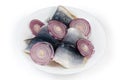 Pickled herring fillets on skin with fresh red onion slices Royalty Free Stock Photo