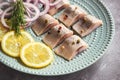 Pickled herring with red onion and lemon slices. Royalty Free Stock Photo