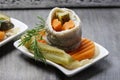 Pickled herring rolls with vegetables on wooden table Royalty Free Stock Photo