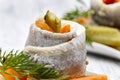 Pickled herring rolls with vegetables on wooden table Royalty Free Stock Photo