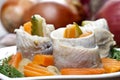 Pickled herring rolls with vegetables on wooden table Royalty Free Stock Photo