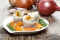 Pickled herring rolls with vegetables on wooden table Royalty Free Stock Photo