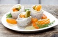 Pickled herring rolls with vegetables on wooden table Royalty Free Stock Photo