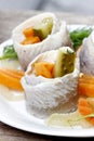 Pickled herring rolls with vegetables on wooden table Royalty Free Stock Photo