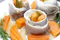 Pickled herring rolls with vegetables on wooden table Royalty Free Stock Photo