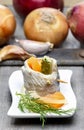 Pickled herring rolls with vegetables on wooden table Royalty Free Stock Photo