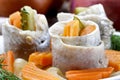 Pickled herring rolls with vegetables on wooden table Royalty Free Stock Photo