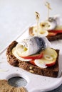 Pickled herring toast with onion and apple