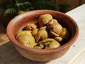 Pickled lemon marinating in a mud pan under the sun