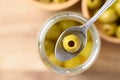 Pickled olives, Pitted green olives in glass jar with spoon Royalty Free Stock Photo