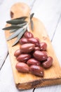 Pickled greek kalamata olives on wooden board Royalty Free Stock Photo