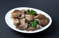 Pickled Oyster Mushrooms with parsley leaf on a plate
