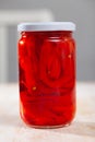 Pickled peppers in a glass jar on wooden table Royalty Free Stock Photo