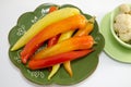 Pickled peppers on a green plate isolated Royalty Free Stock Photo