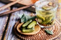 Pickled pickles in a glass jar on a wooden table Royalty Free Stock Photo